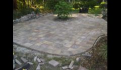 Free form paver patio with sailor course border during construction.