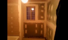 Installation of mold resistant drywall for bathroom.