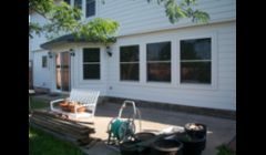 We change the window on the far left from a door.\ntook out 2 windows and made a patio door. Cement fiber siding and new windows throughout.  Amazing results.