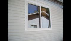 Vinyl siding is the right complement for this ranch style home.  New windows will reduce the electric bill and decrease outside noises.