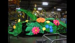 I painted the translucent colored flowers,the mascot lightning bug, Blaze, the initial coating, and helped with the glittering of this Tinker Bell float.