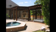 Outdoor Fireplace with hot tub and cedar arbor