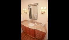 Elegant cherry vanity and marble countertop.