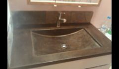 Solid concrete counter with integral sink, a natural slate back splash tied it all together