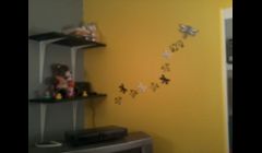 This is a corner wall of the nursery. We put in floating shelves for stores and carried on the stenciled designs...