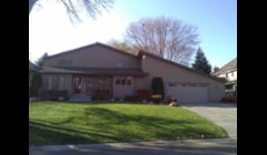 New window, siding, and exterior stone work.