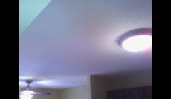 An old popcorn ceiling transformed to a knock down finish and repaint. Knock down provides a nice alternative to popcorn and is easier to repaint in the future.