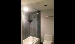 Bathroom Remodel Shower Stall with Dark Tile and Glass Door in Boston