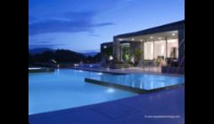 Vanishing edge & perimeter overflow elements highlight this complex swimming pool & spa.