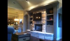 Mounted TV with universal remote integrated with automated lighting.