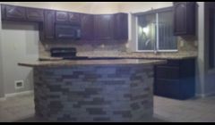 Notice the stone on the island matches the fireplace.