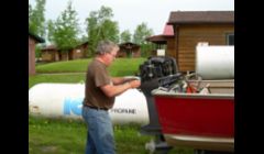 Repairing outboard motor at a Bible Camp in Northwest Ontario