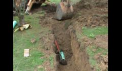Trenching for a storm water system for downspouts and driveway drains.