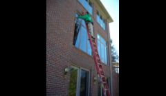 One of our crew members washing windows in Brighton, MI. We climb to each and every window; we never wash windows from the ground with an extension pole like some companies!