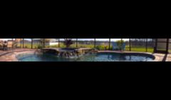 Custom pool/spa with natural stone. Caribbean Blue Pebble Tec Finish
