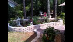 Raised planter and patio installed by Tampa Landscapes.